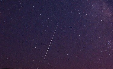 A Perseid meteor streaks across the sky during the Perseid meteor shower on Tuesday, Aug. 11, 2009 in Vinton, Calif. (AP Photo/Kevin Clifford)